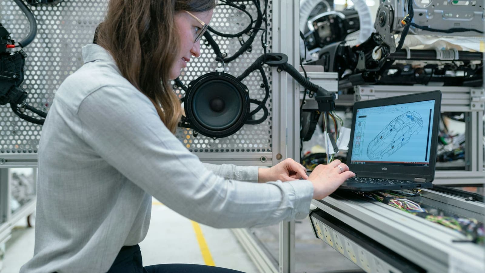 Une ingénieure travaille sur un ordinateur portable dans un laboratoire d'essais industriels.